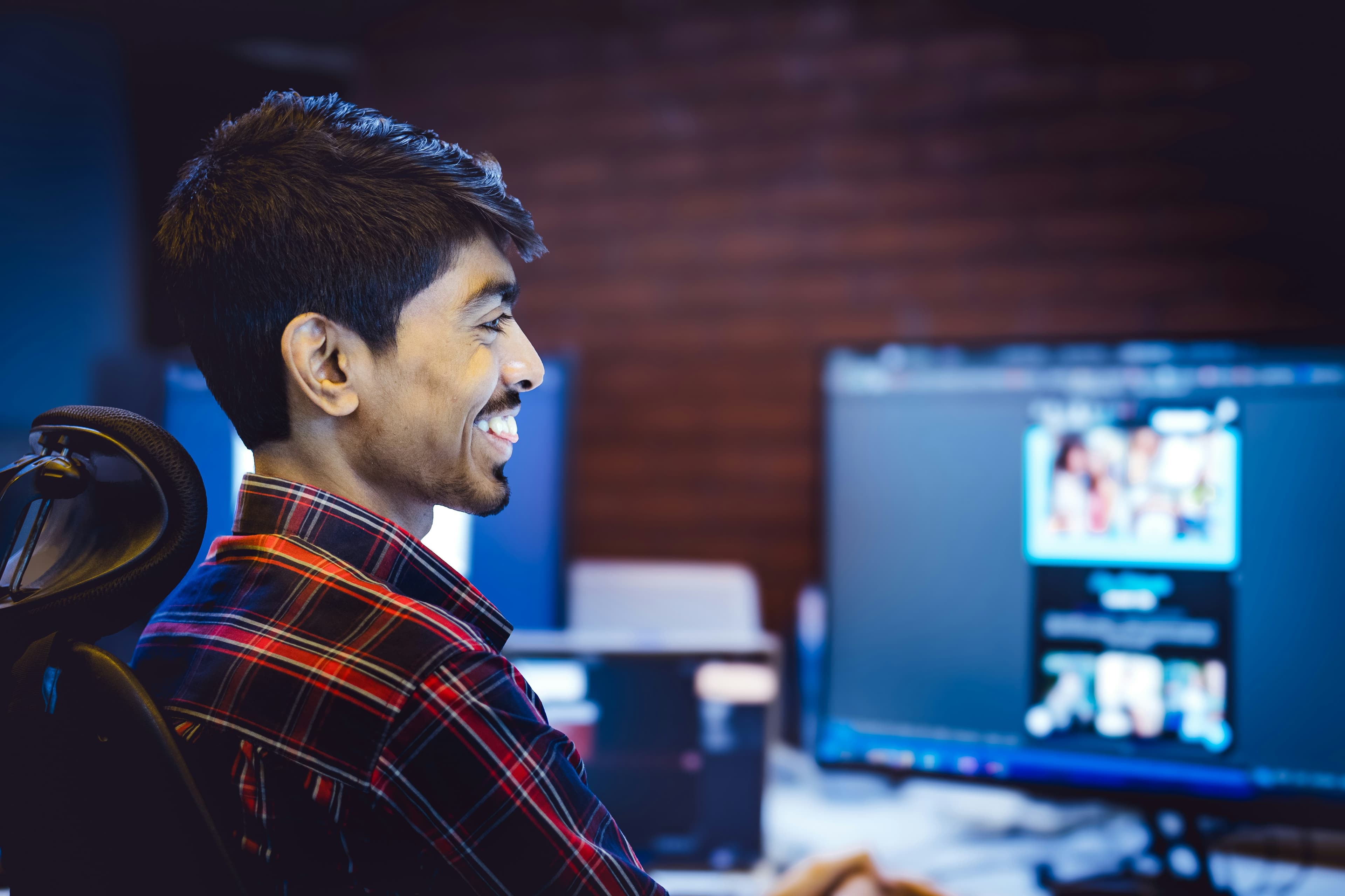 A developer smiling confidently at his desk
