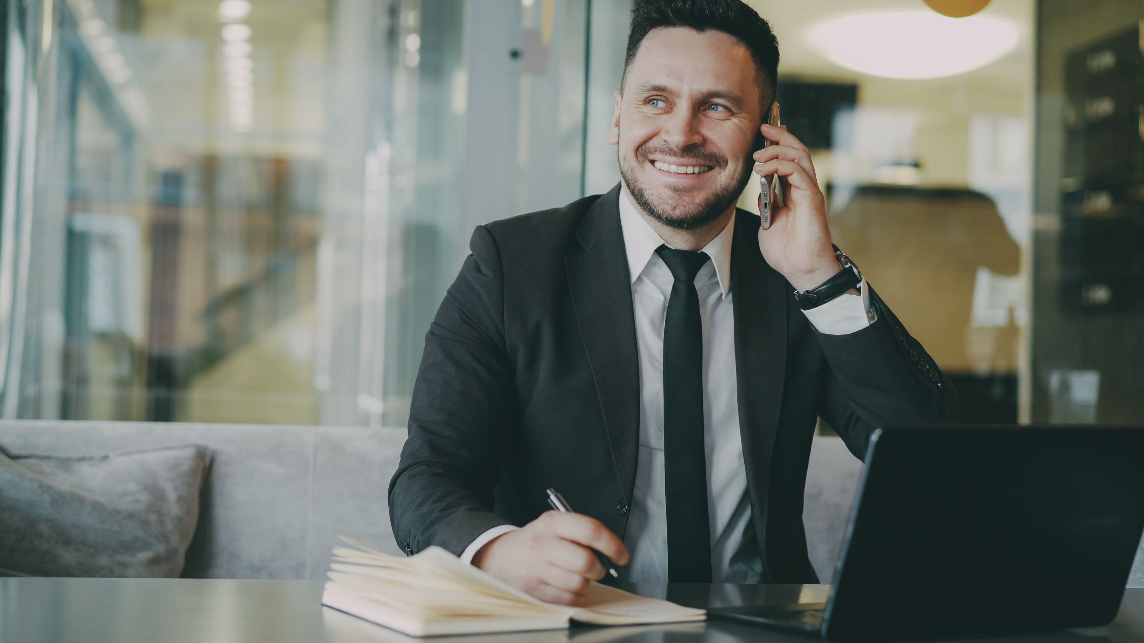 A professional confidently taking a call at his desk