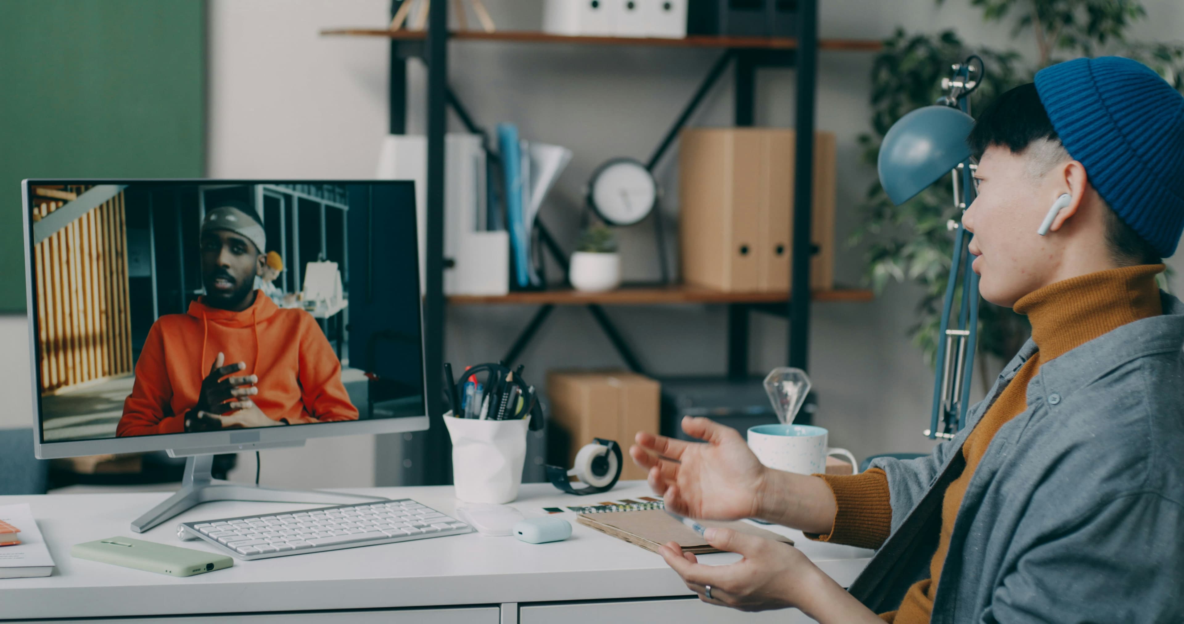 A professional engaged in a live video call at his desk